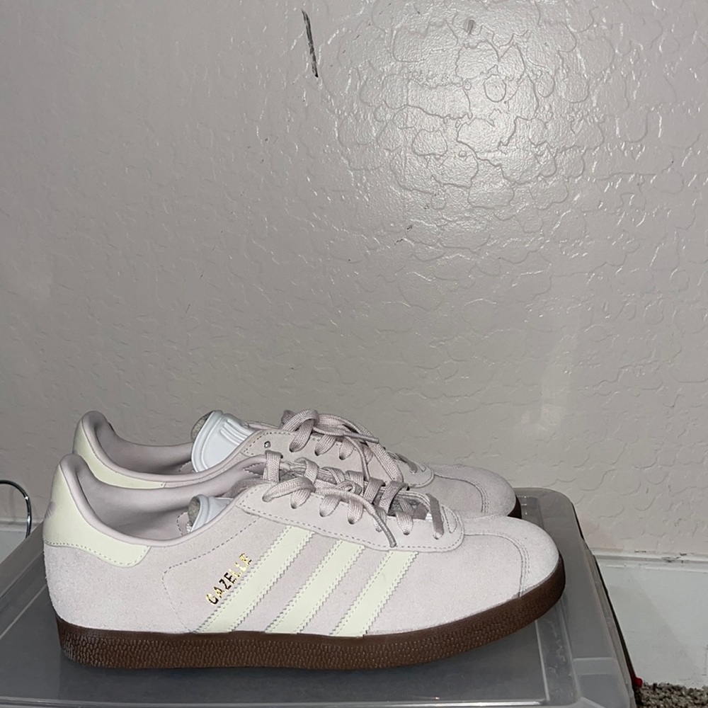 Adidas Gazelle white leather stripes and light purple suede shoes.